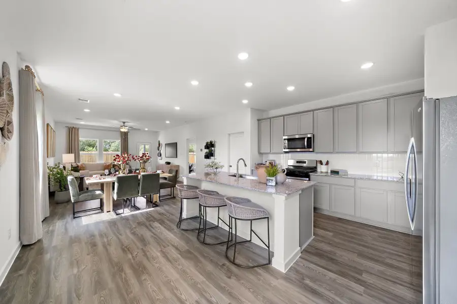 A kitchen with a wood floor. A kitchen with a wood floor.