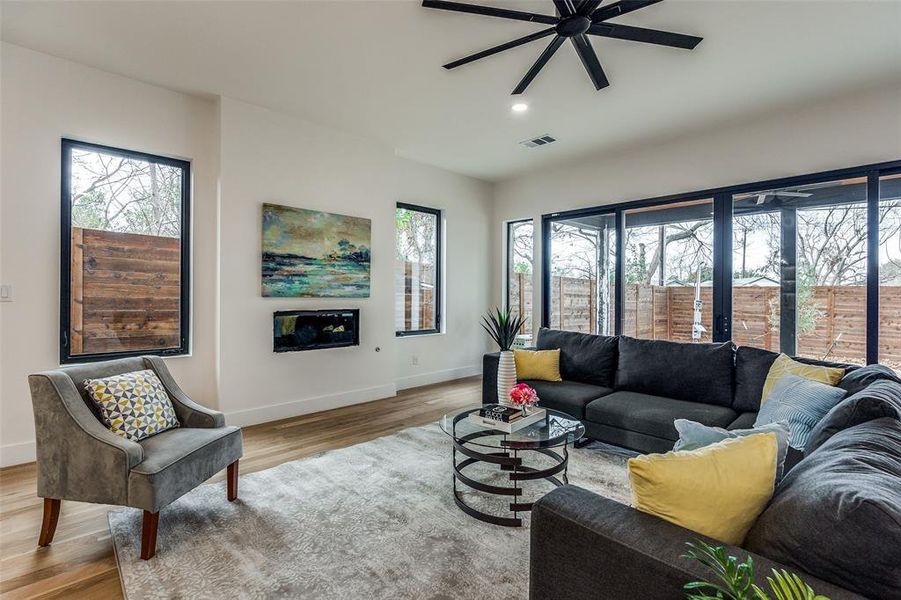 Living room with ceiling fan and light wood-type flooring