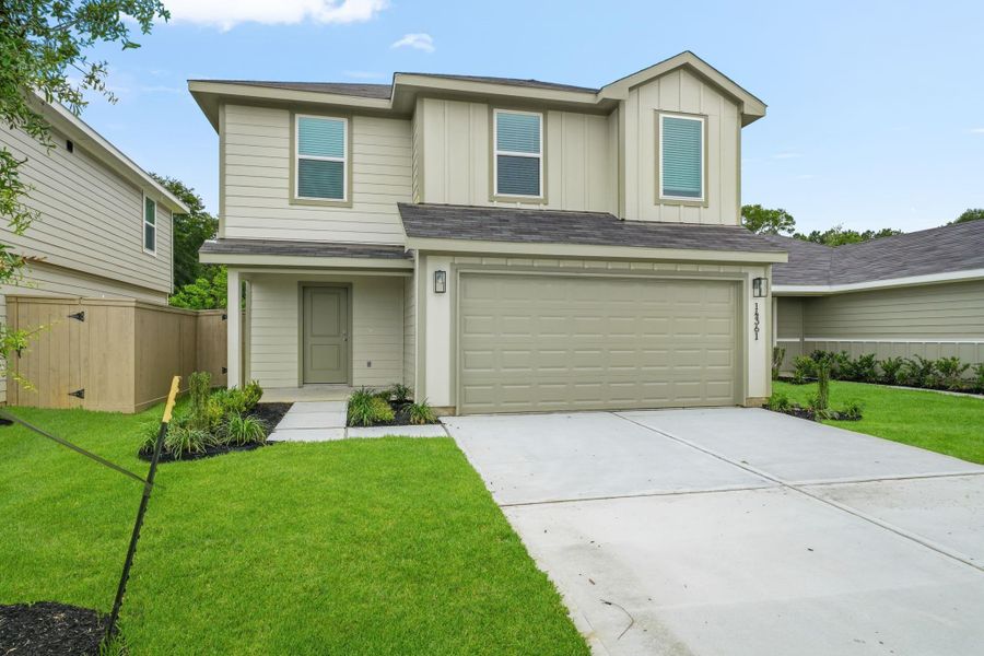 Front exterior of a new home in The Canopies, Splendora, TX, highlighting curb appeal (Image 2). Front exterior of a new home in The Canopies, Splendora, TX, highlighting curb appeal (Image 2).