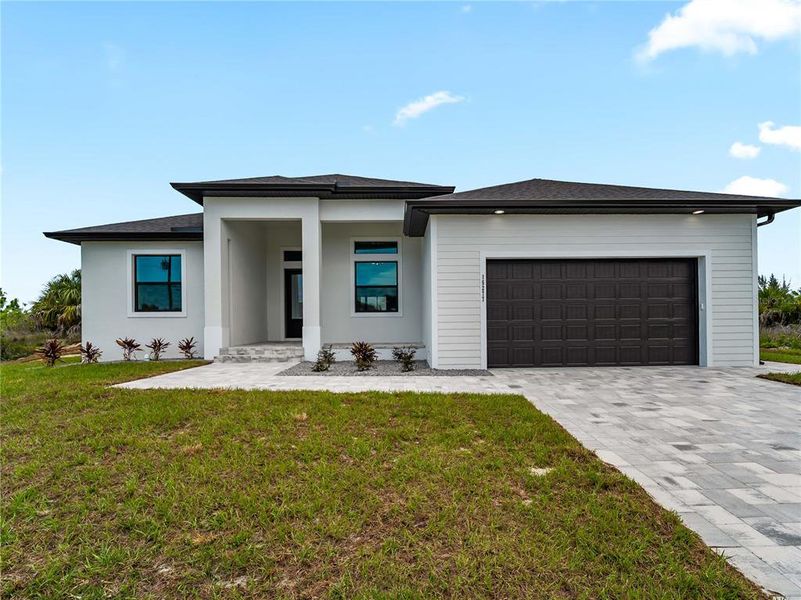 Front exterior of a new home in , Port Charlotte, FL, highlighting curb appeal (Image 1). Front exterior of a new home in , Port Charlotte, FL, highlighting curb appeal (Image 1).