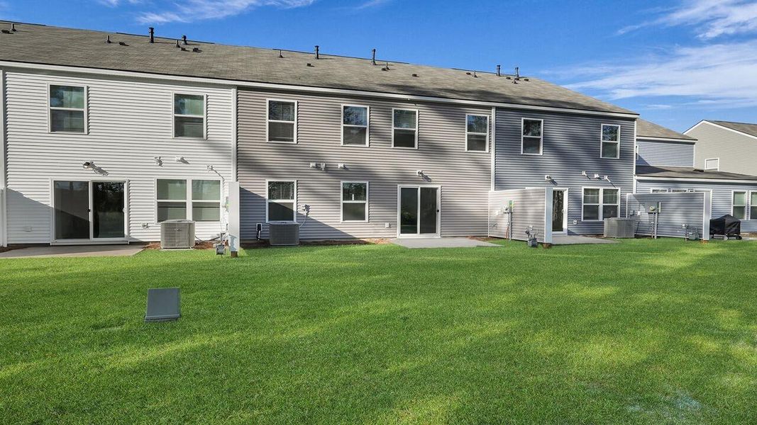 Exterior details and patio area of a home in Pine Hills Townhomes at Cane Bay, Summerville (Image 17). Exterior details and patio area of a home in Pine Hills Townhomes at Cane Bay, Summerville (Image 17).