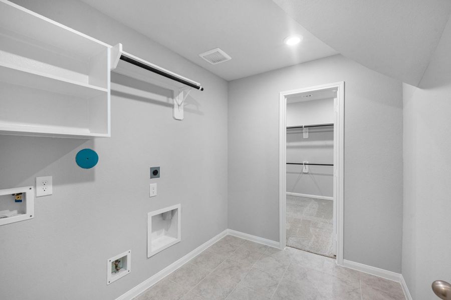 View of the laundry room with plenty of storage space.