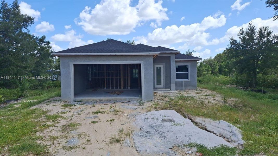 Front exterior of a new home in , Lehigh Acres, FL, highlighting curb appeal (Image 2).