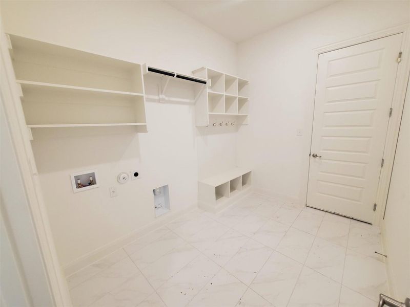 Laundry area featuring hookup for an electric dryer, hookup for a gas dryer, laundry area, marble finish floor, and hookup for a washing machine Laundry area featuring hookup for an electric dryer, hookup for a gas dryer, laundry area, marble finish floor, and hookup for a washing machine