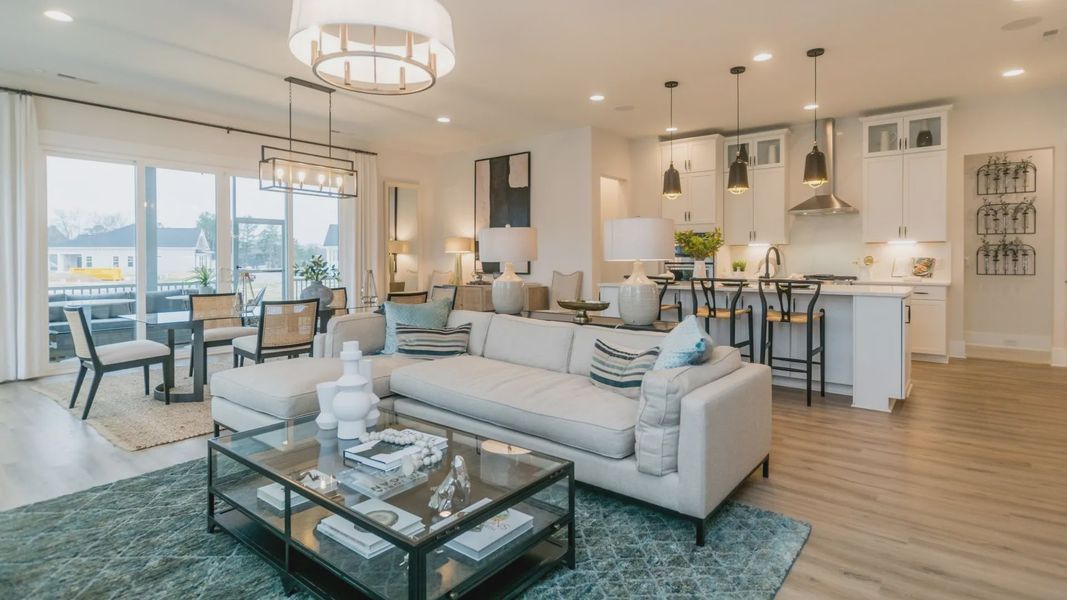 The Curator Plan by DBR Homes kitchen and living area with modern features in Fort Mill, SC. The Curator Plan by DBR Homes kitchen and living area with modern features in Fort Mill, SC.