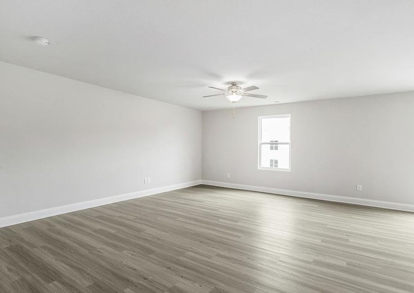 Living room with vinyl flooring and ceiling fan.