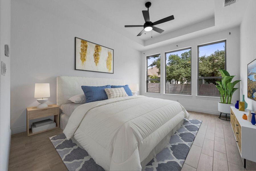 Sunny bedroom with large windows and neutral finishes, virtually staged to highlight its comfortable layout and serene atmosphere.