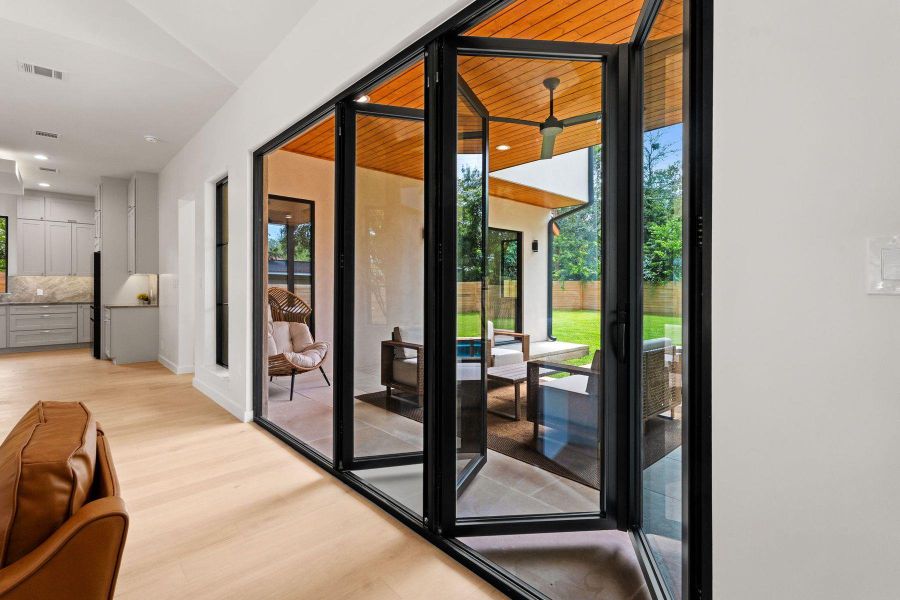 Retractable glass doors merge indoor comfort with a secluded outdoor entertaining space and lush lawn. Retractable glass doors merge indoor comfort with a secluded outdoor entertaining space and lush lawn.