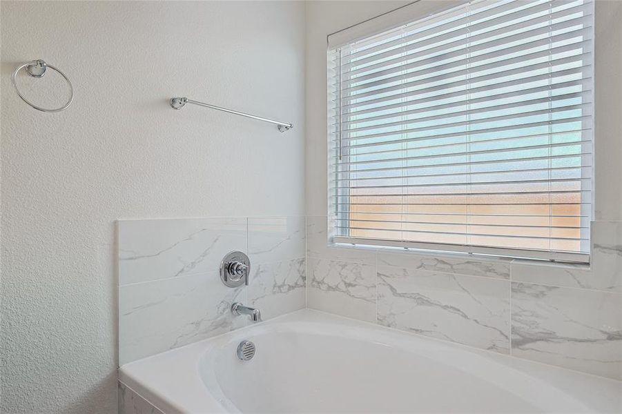 Bathroom featuring a relaxing tiled tub