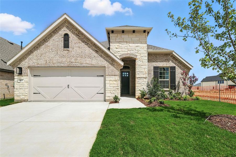 French country inspired facade featuring stone siding, brick siding, concrete driveway, a garage, and a shingled roof French country inspired facade featuring stone siding, brick siding, concrete driveway, a garage, and a shingled roof