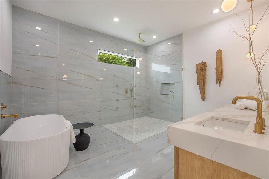 Full bath with a marble finish shower, marble finish flooring, a soaking tub, vanity, and recessed lighting Full bath with a marble finish shower, marble finish flooring, a soaking tub, vanity, and recessed lighting