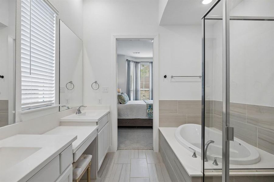 Double vanity with undermount sinks, white countertops, and chrome fixtures