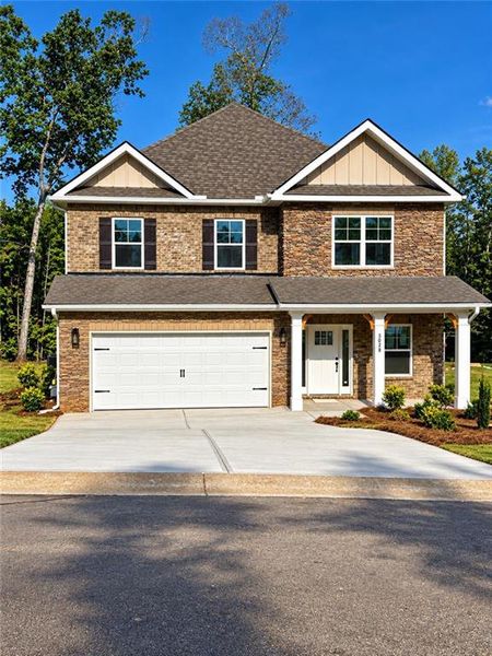 Front exterior of a new home in Mirror Lake at South Harbour, Villa Rica, GA, highlighting curb appeal (Image 1). Front exterior of a new home in Mirror Lake at South Harbour, Villa Rica, GA, highlighting curb appeal (Image 1).