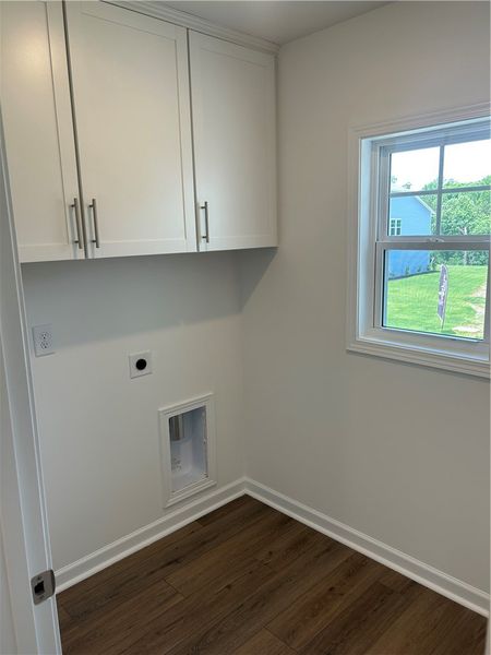 Ample storage cabinetry and hardwood flooring enha