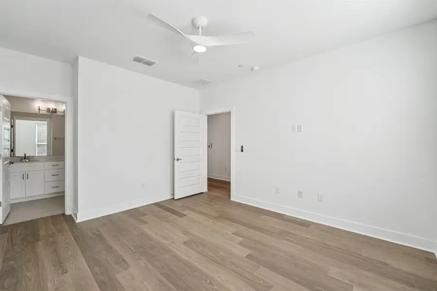 The primary bedroom sits on the entry level, offering a quiet retreat or caneasily be transformed into a private office or studio space. (Sample photo of finishes and layout)
