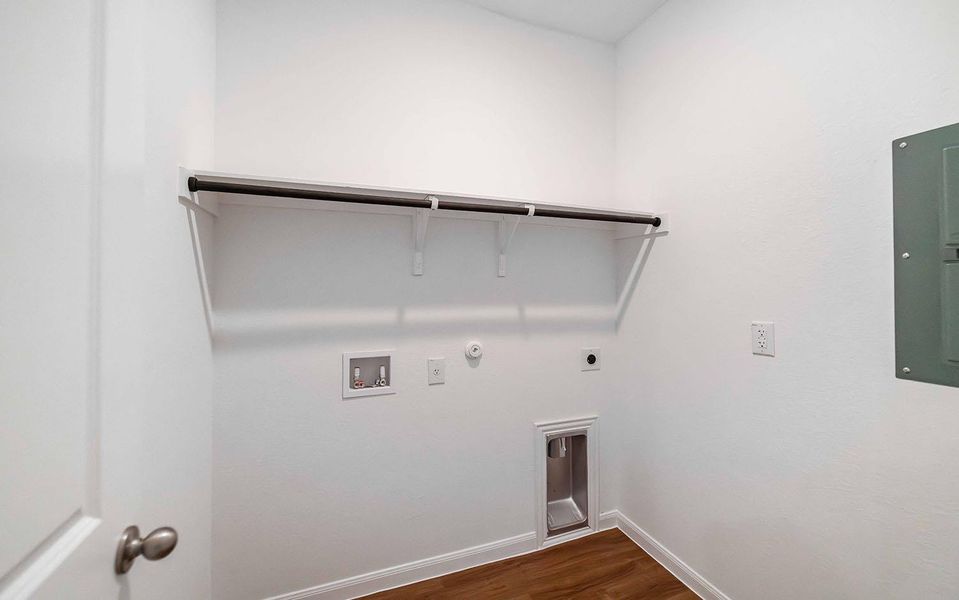 Laundry area with dark wood-type flooring, hookup for a gas dryer, hookup for a washing machine, electric panel, and hookup for an electric dryer Laundry area with dark wood-type flooring, hookup for a gas dryer, hookup for a washing machine, electric panel, and hookup for an electric dryer