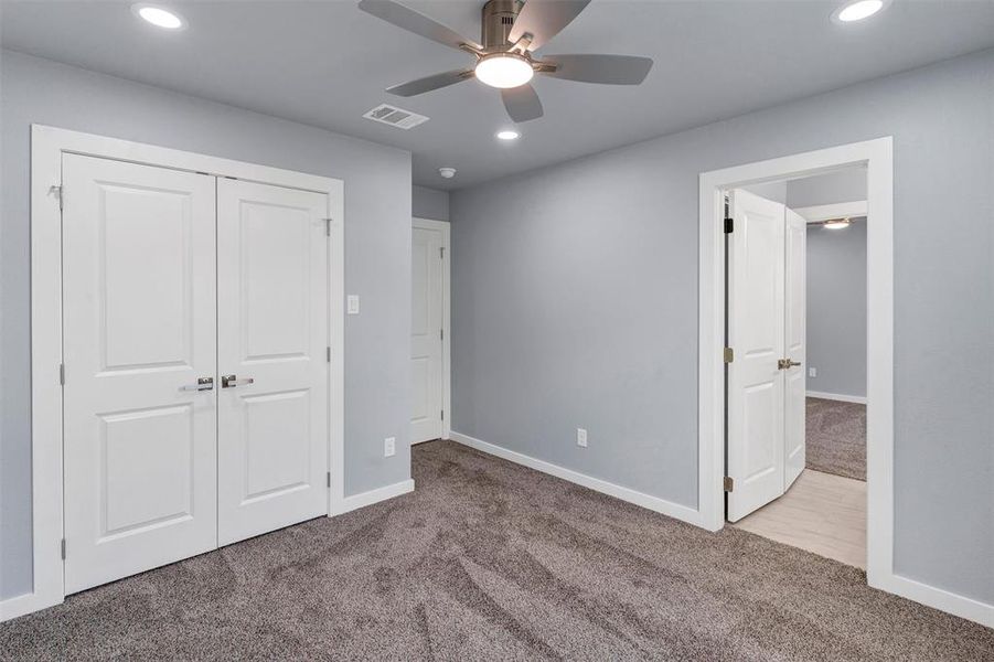 Unfurnished bedroom featuring carpet floors, recessed lighting, a closet, and ceiling fan