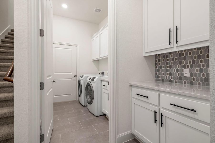 Laundry area featuring cabinet space, independent washer and dryer, light tile patterned floors, and recessed lighting Laundry area featuring cabinet space, independent washer and dryer, light tile patterned floors, and recessed lighting