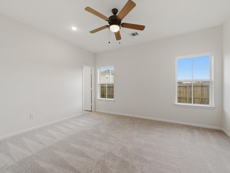 The spacious primary suite offers a peaceful retreat designed for comfort, privacy, and everyday ease.