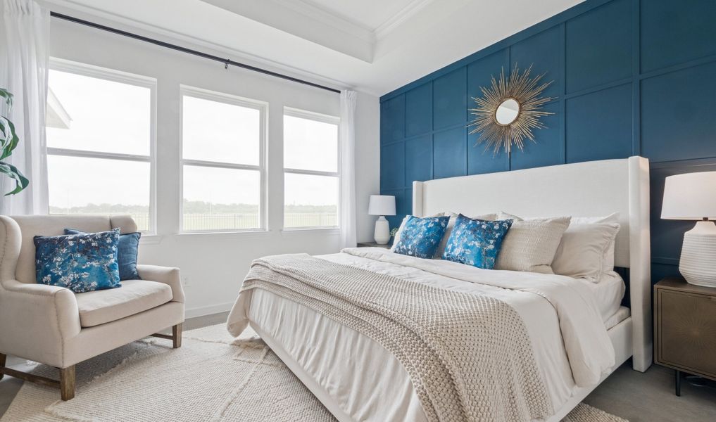 Primary suite with tray ceiling & decorative feature wall Primary suite with tray ceiling & decorative feature wall