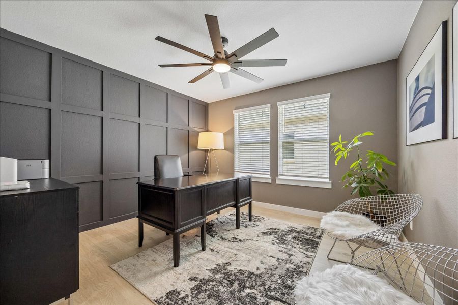 This is the private dedicated office!  The luxury vinyl plank was added after purchasing and matches the other LVP in the house ... as was the custom decorative wood accent wall and ceiling fan.