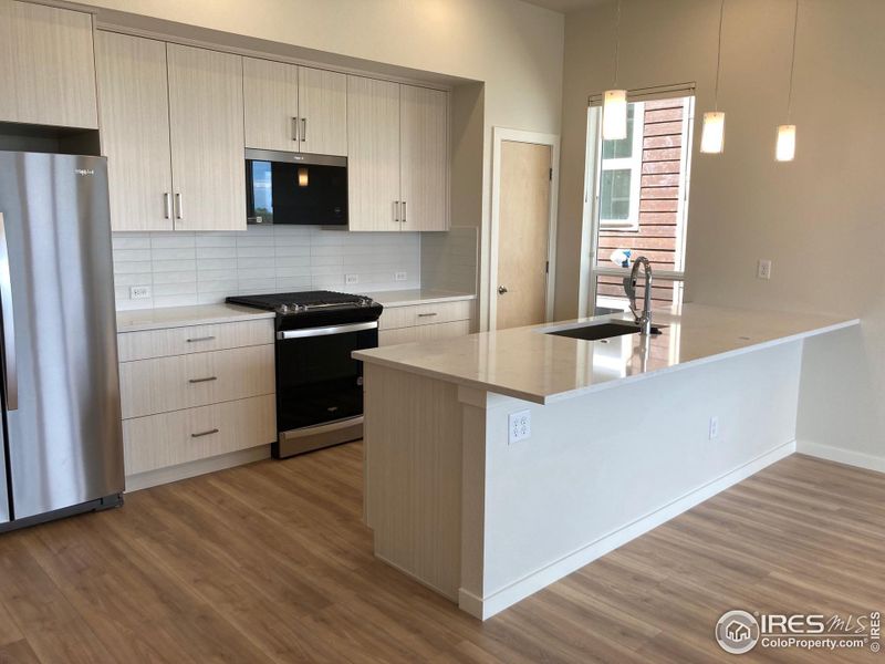 Kitchen with island breakfast bar and pantry