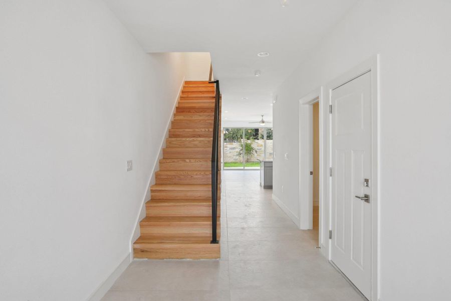 Staircase featuring concrete floors and recessed lighting