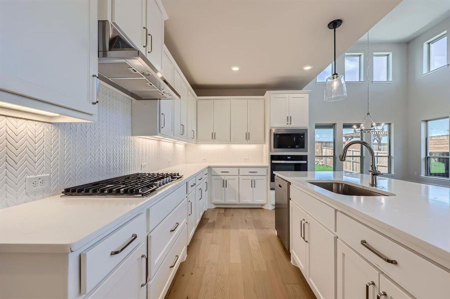 Kitchen with white cabinets, sink, plenty of natural light, and stainless steel appliances