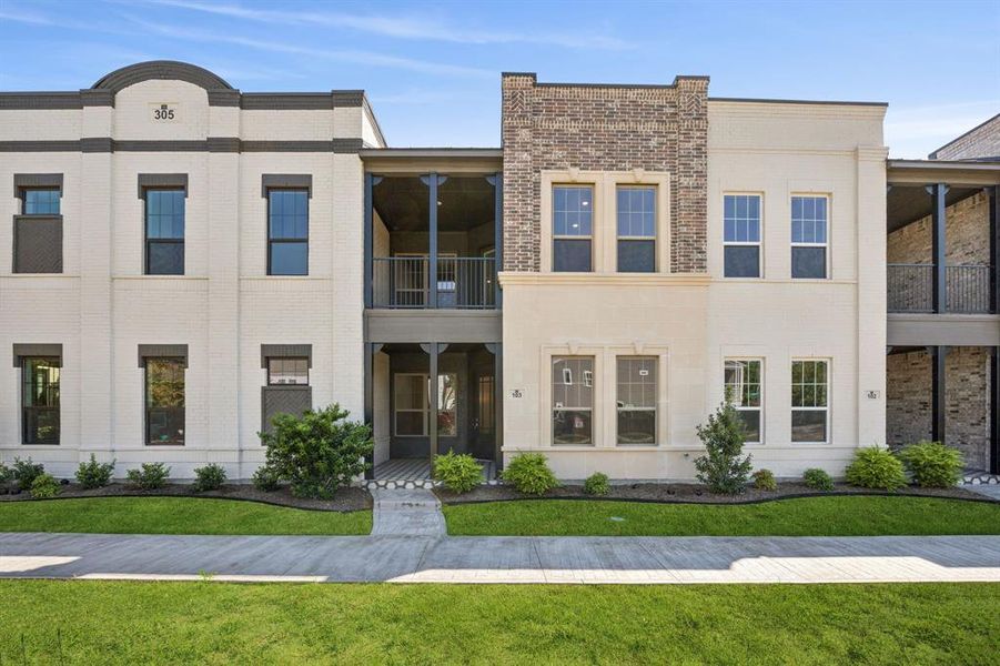 View of front entry with large front porch and balcony.