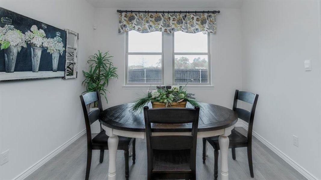 Light wood-finish flooring complements the neutral wall color