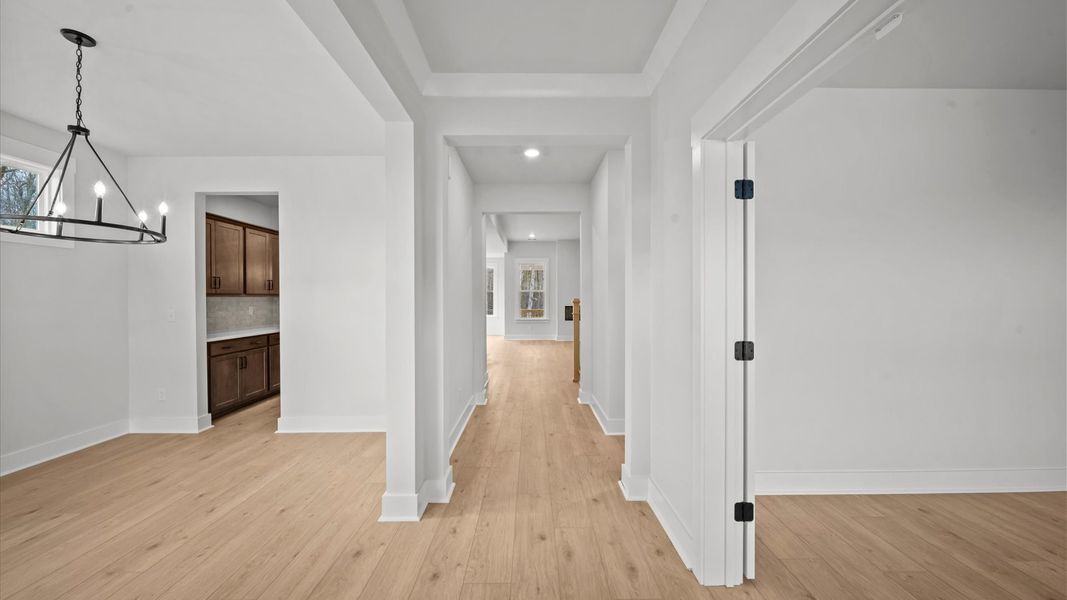 Highly functional foyer with hardwood flooring that flows seamlessly into living spaces