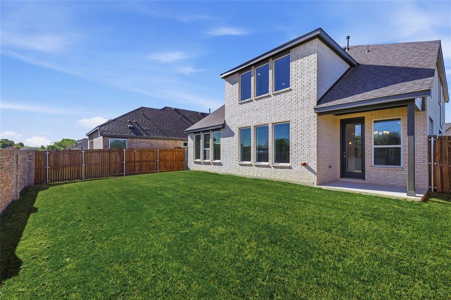 Back of property with brick siding, a patio, a fenced backyard, and roof with shingles Back of property with brick siding, a patio, a fenced backyard, and roof with shingles