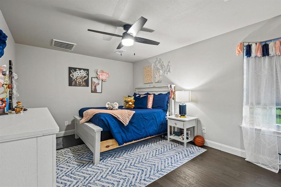 Bedroom featuring dark wood-style floors and a ceiling fan Bedroom featuring dark wood-style floors and a ceiling fan