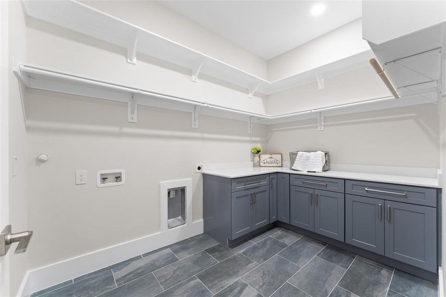 Laundry area with hookup for an electric dryer, cabinet space, and washer hookup Laundry area with hookup for an electric dryer, cabinet space, and washer hookup