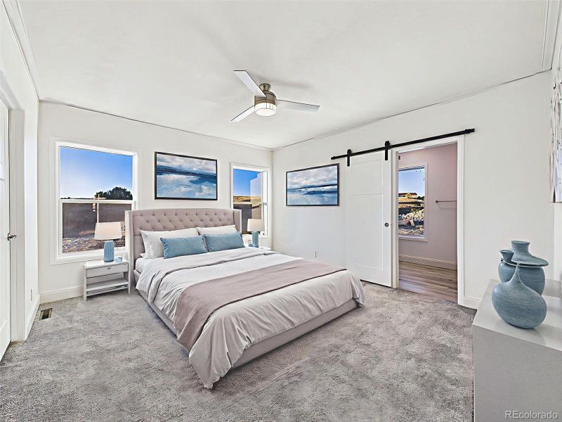 Virtually Staged Spacious primary suite with bright natural light, plush carpeting, and barn door access to ensuite bath. Virtually Staged Spacious primary suite with bright natural light, plush carpeting, and barn door access to ensuite bath.