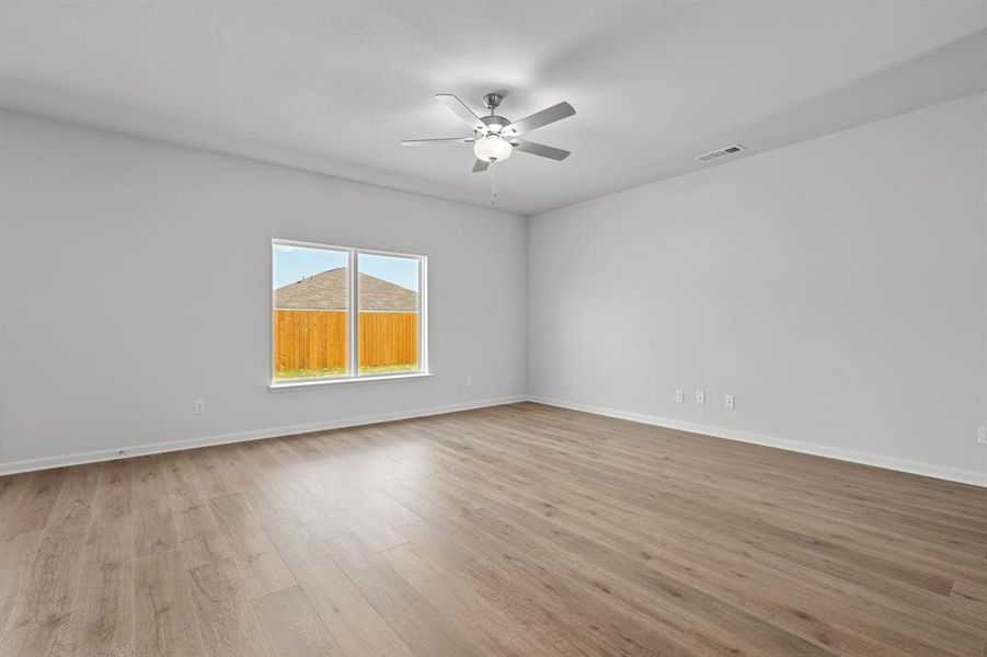 Spare room with light wood-type flooring and a ceiling fan Spare room with light wood-type flooring and a ceiling fan