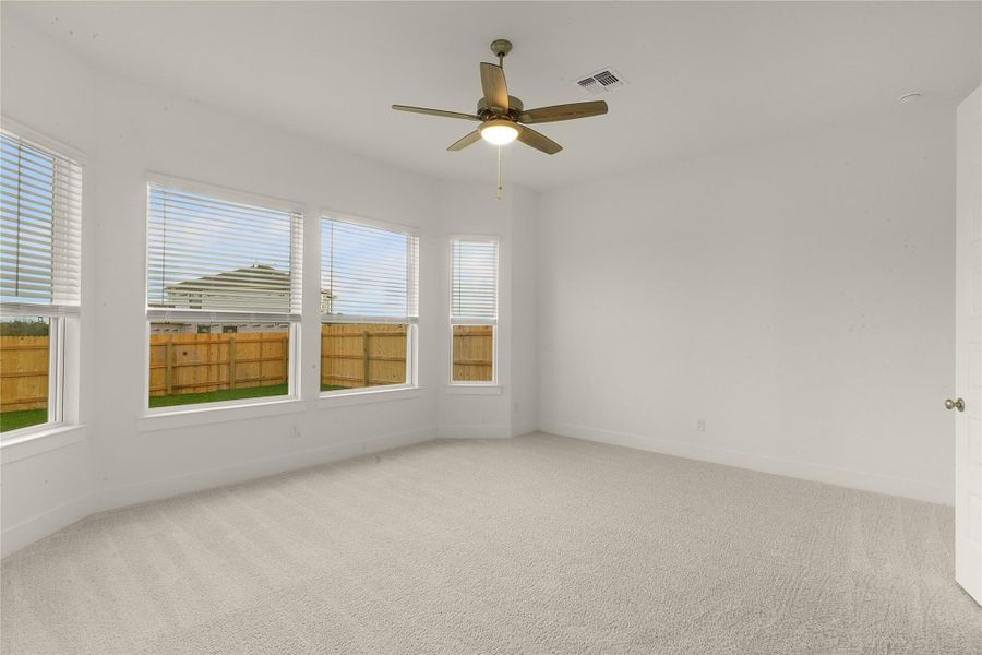 Spare room with light colored carpet and a ceiling fan