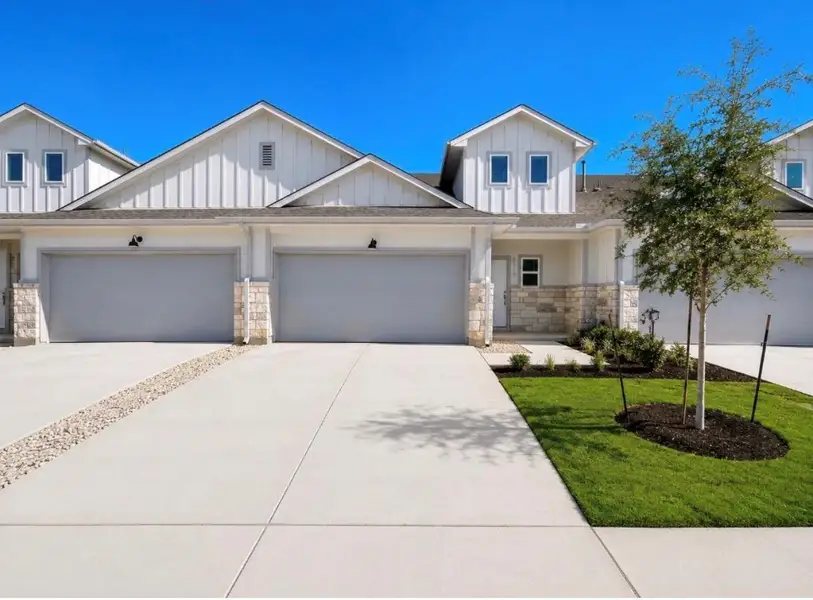 Front exterior of a new home in Wellspring, Round Rock, TX, highlighting curb appeal (Image 2).
