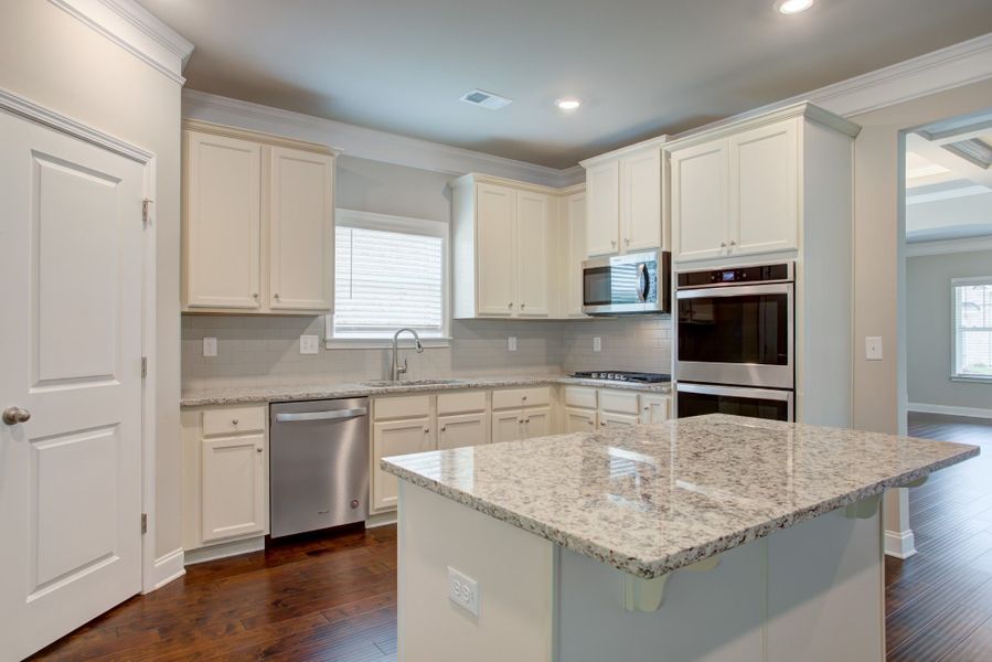 Well-designed kitchen overlooks the breakfast are and the great room