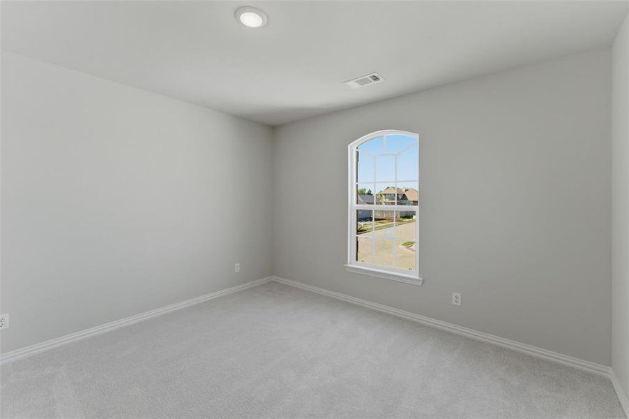 Unfurnished room with light colored carpet and baseboards