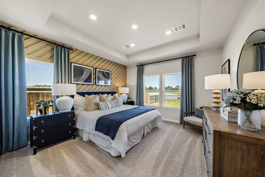 A bedroom with a large mirror.