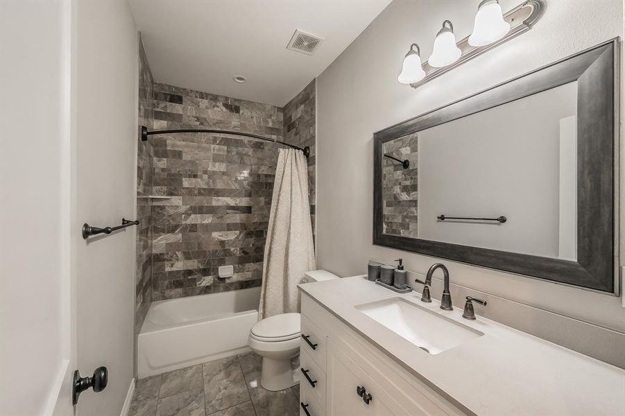 Bathroom featuring shower / tub combo and vanity Bathroom featuring shower / tub combo and vanity