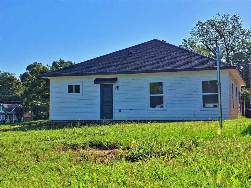 Rear view of house featuring roof with shingles Rear view of house featuring roof with shingles