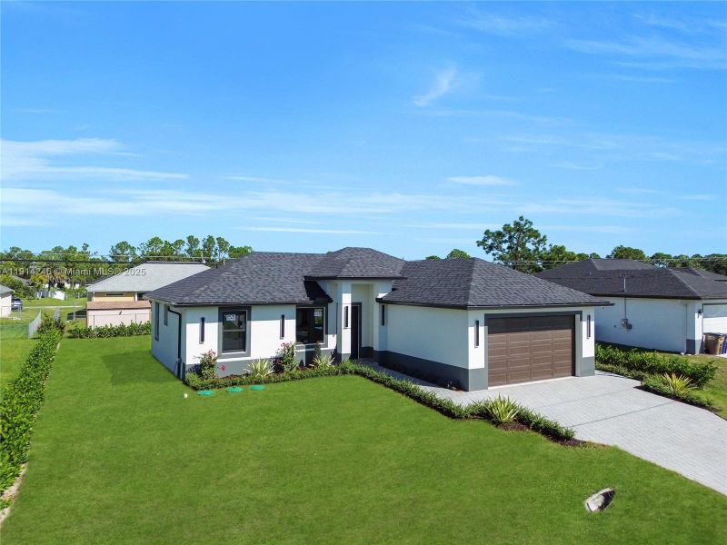 Front exterior of a new home in , Lehigh Acres, FL, highlighting curb appeal (Image 2). Front exterior of a new home in , Lehigh Acres, FL, highlighting curb appeal (Image 2).