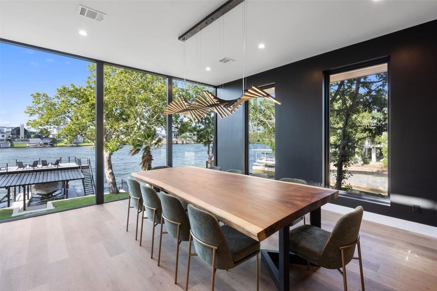 Stunning formal dining room that appears to float above the water.