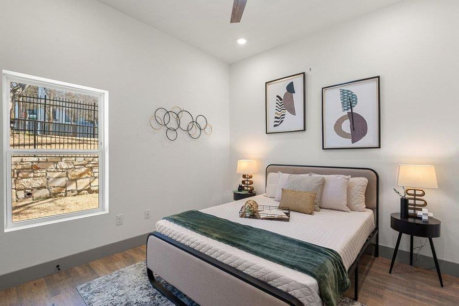 Bedroom featuring dark wood-type flooring, ceiling fan, and recessed lighting