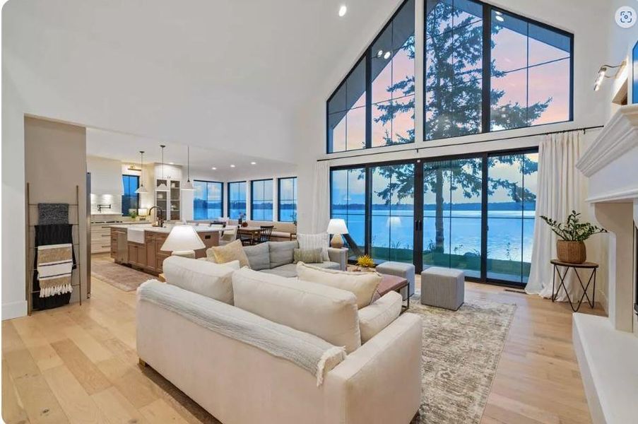 Living room Vaulted Ceiling with Massive Water View perfect for views of Sunsets open to Kitchen and Dining Room