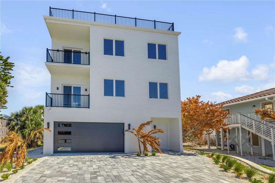 Front exterior of a new home in , New Smyrna Beach, FL, highlighting curb appeal (Image 2). Front exterior of a new home in , New Smyrna Beach, FL, highlighting curb appeal (Image 2).