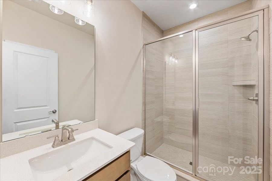 First Floor Full Bath with Tile Surround Walk-In Shower.