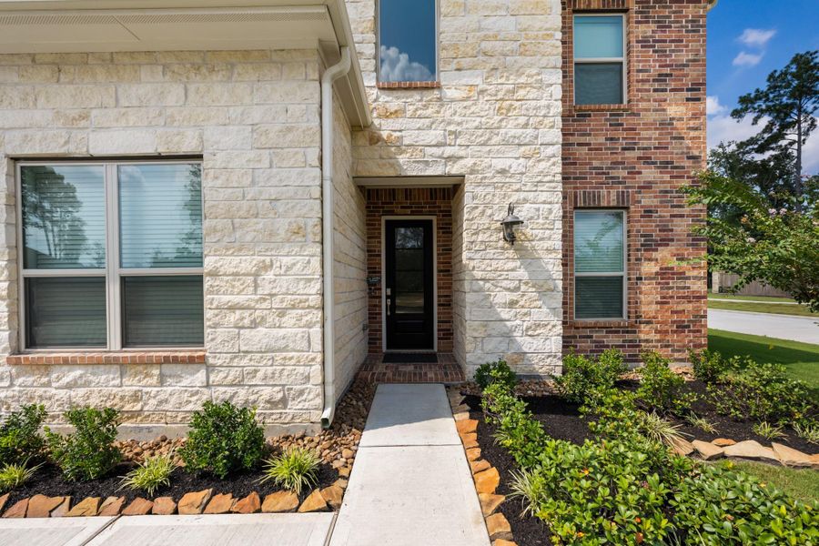 Front exterior of a new home in The Highlands: Pinnacle Collection, Porter Heights, TX, highlighting curb appeal (Image 1).